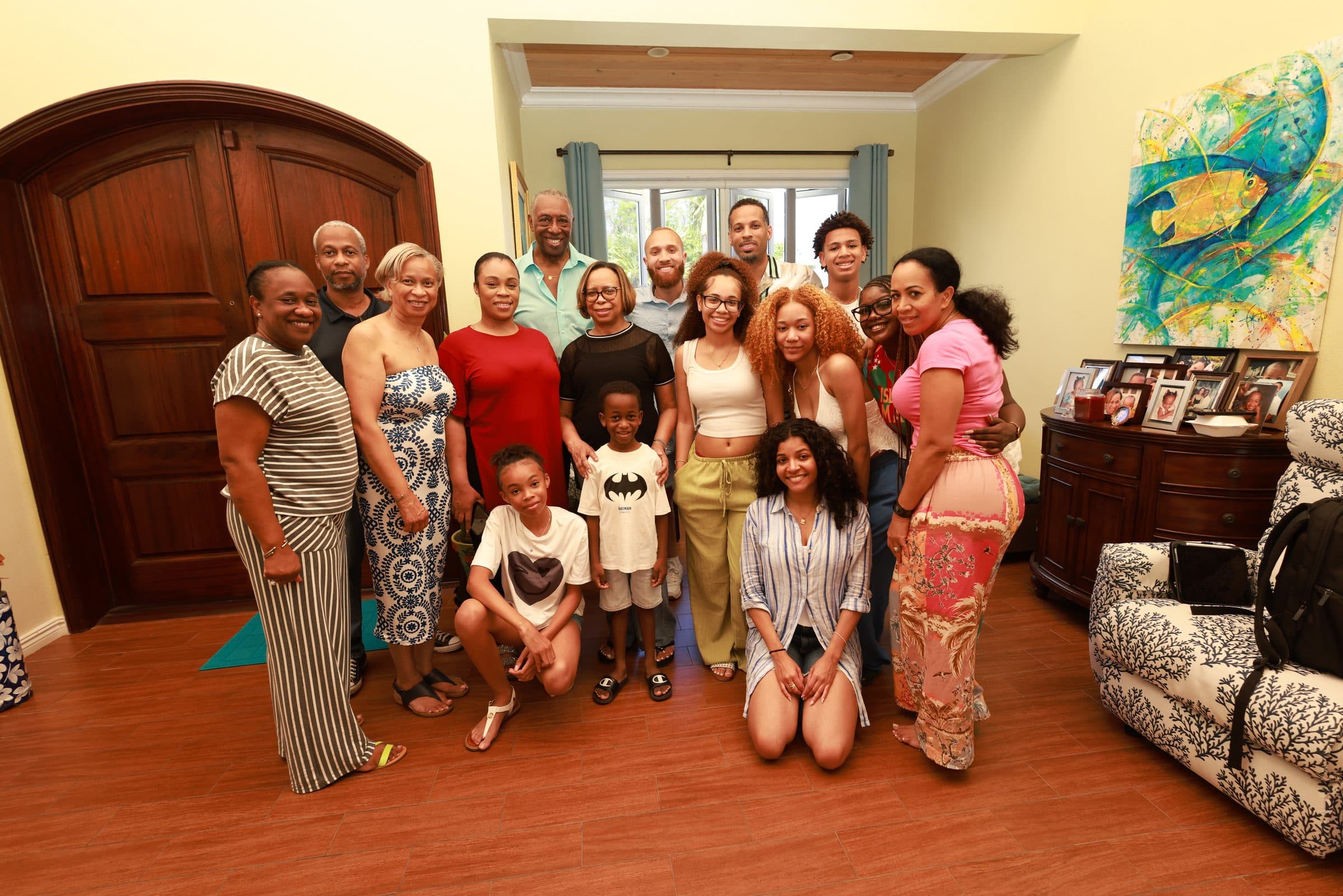Ray and Alexia surrounded by family in a warm living room gathering